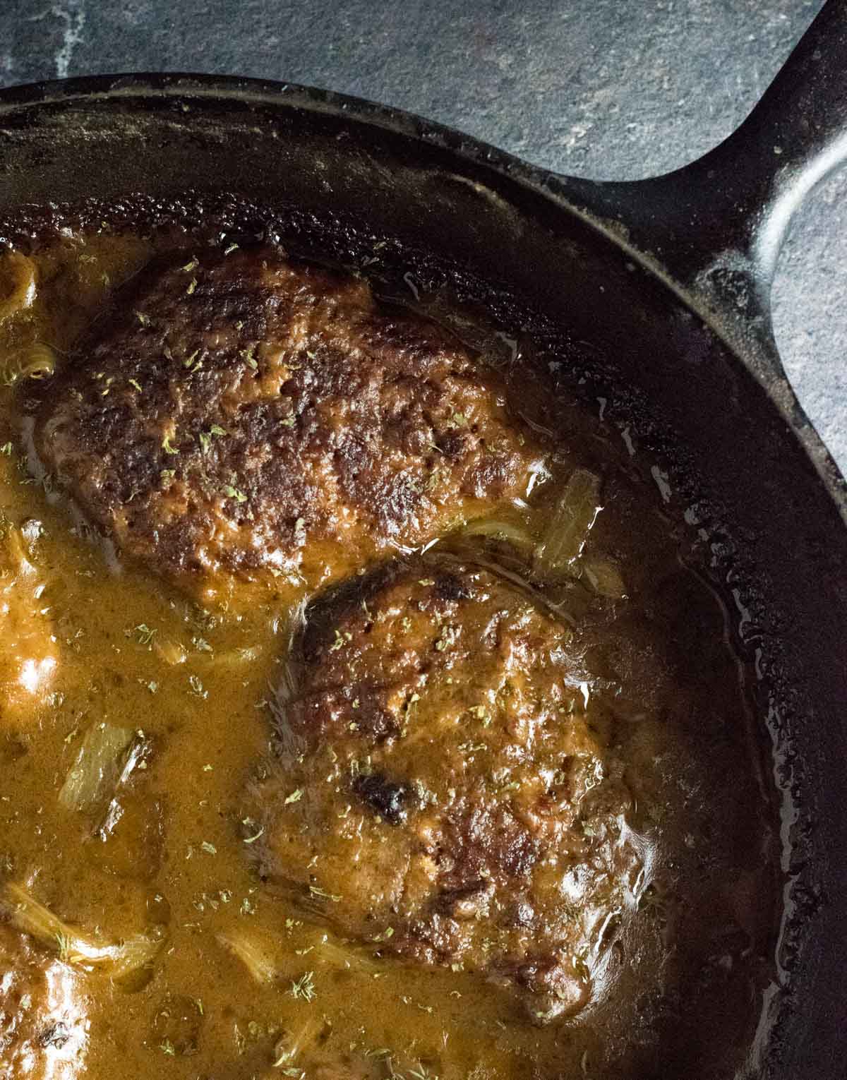 Baking cube steaks in cast iron skillet.