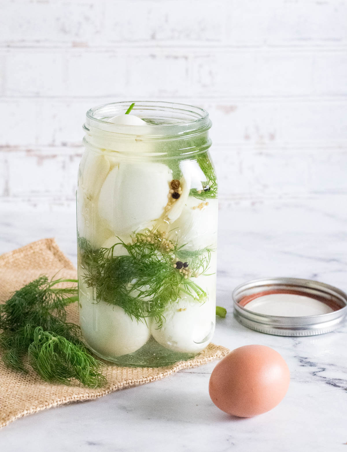 Dill pickled eggs in mason jar.