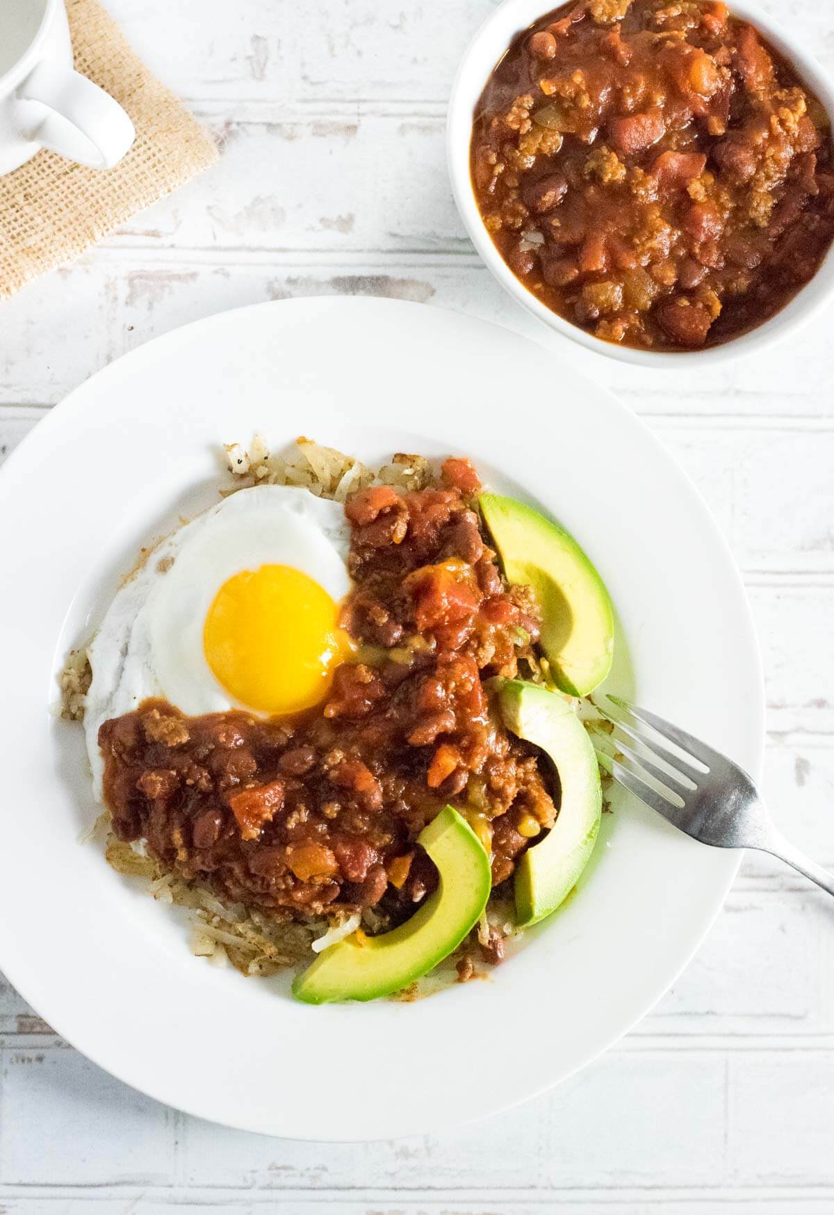 Serving breakfast chili with eggs.