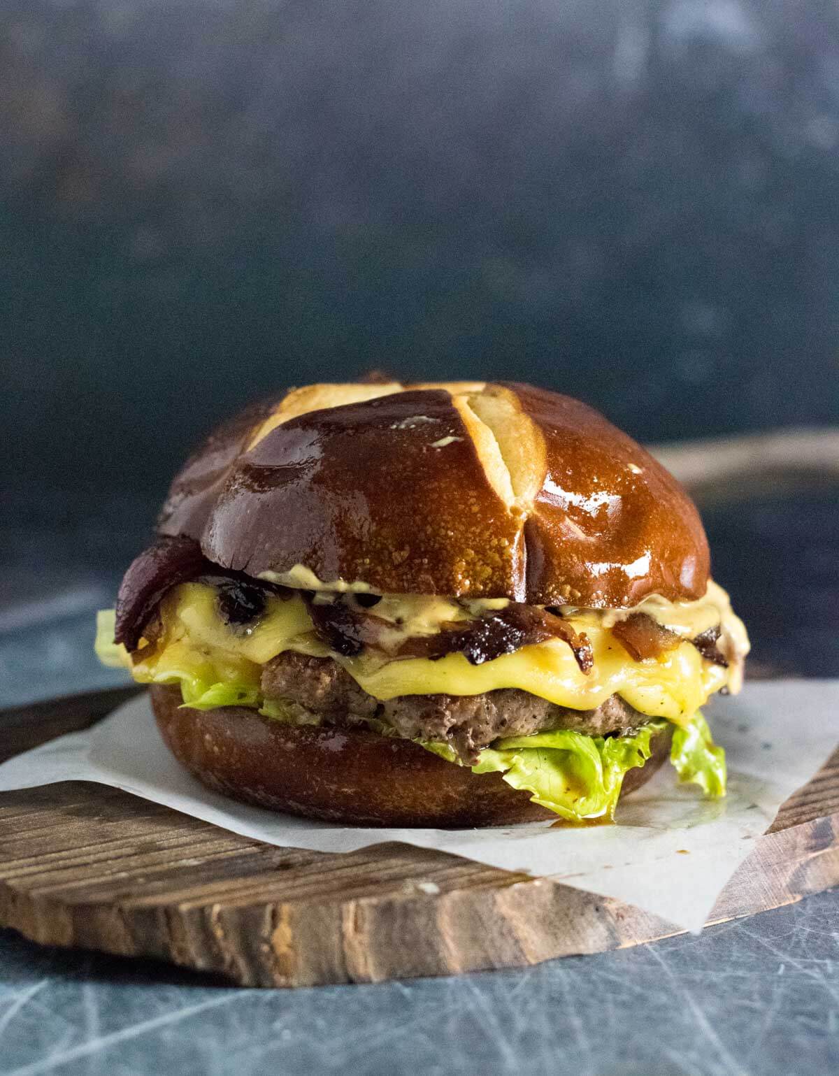 Juicy venison burger on plate.