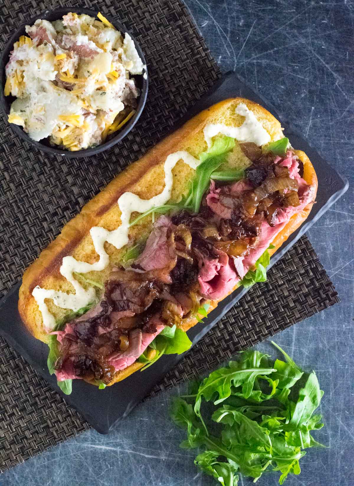 Assembling the prime rib sandwich.