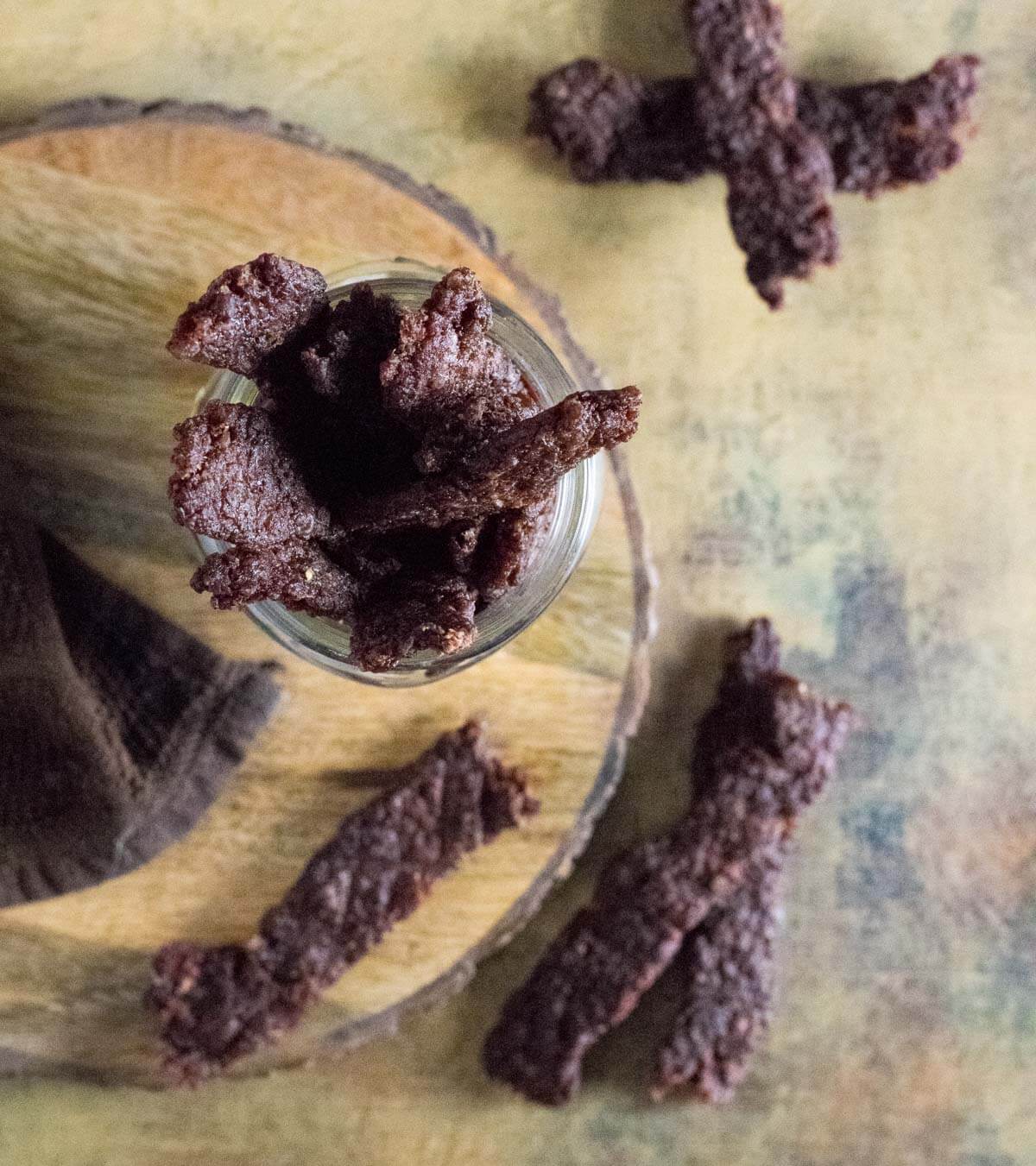 Ground venison jerky in container.