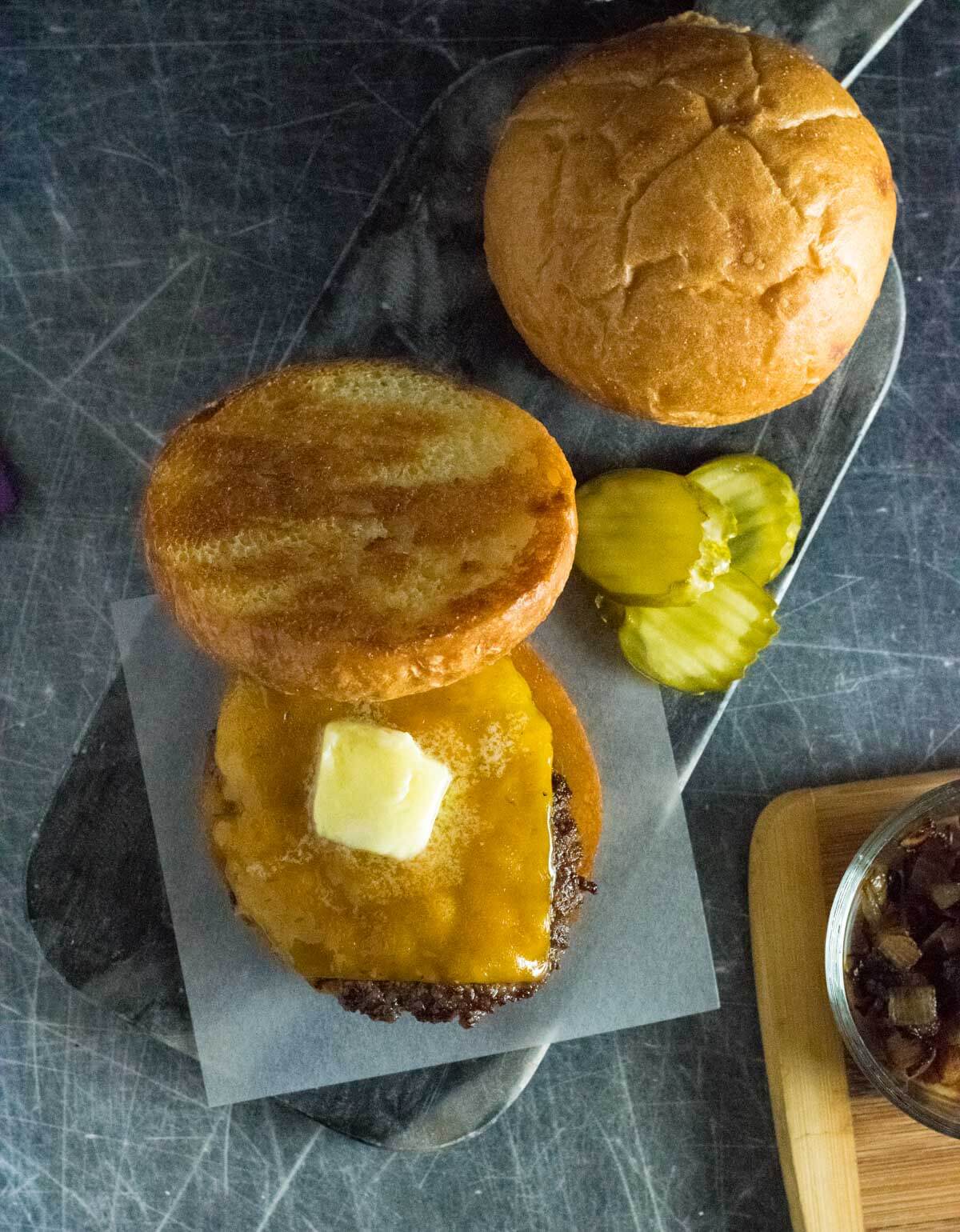 Melting butter on burger patty.