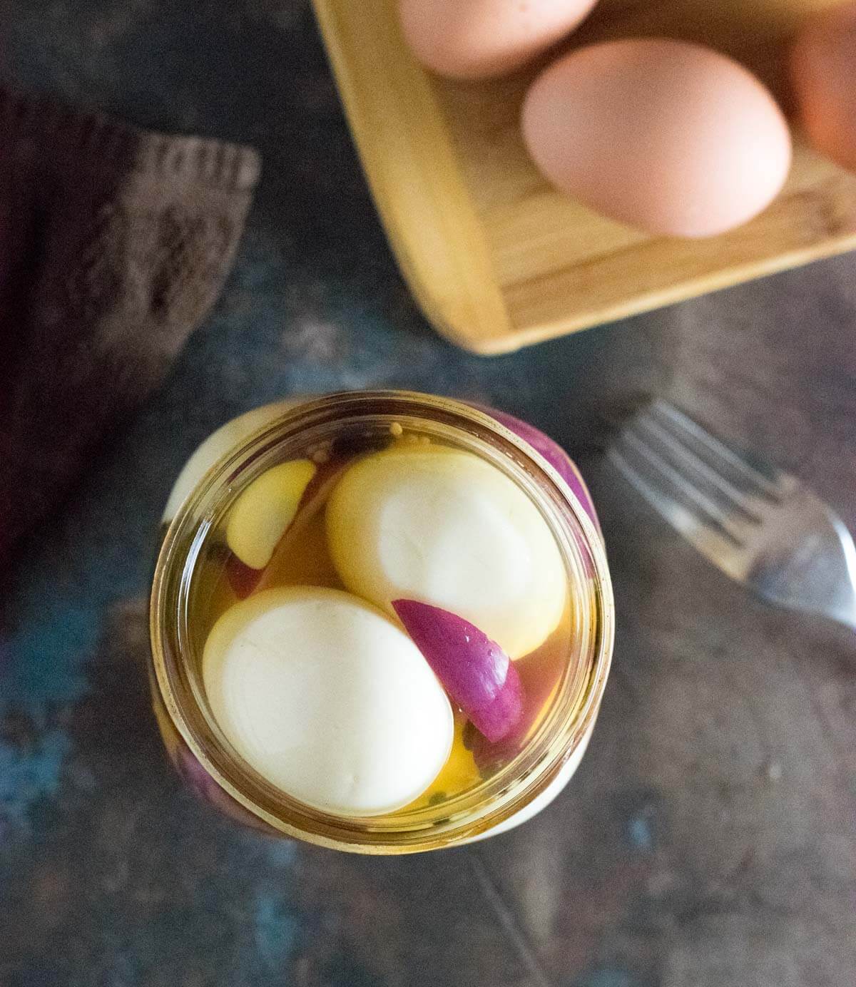 Serving pickled eggs with apple cider vinegar.
