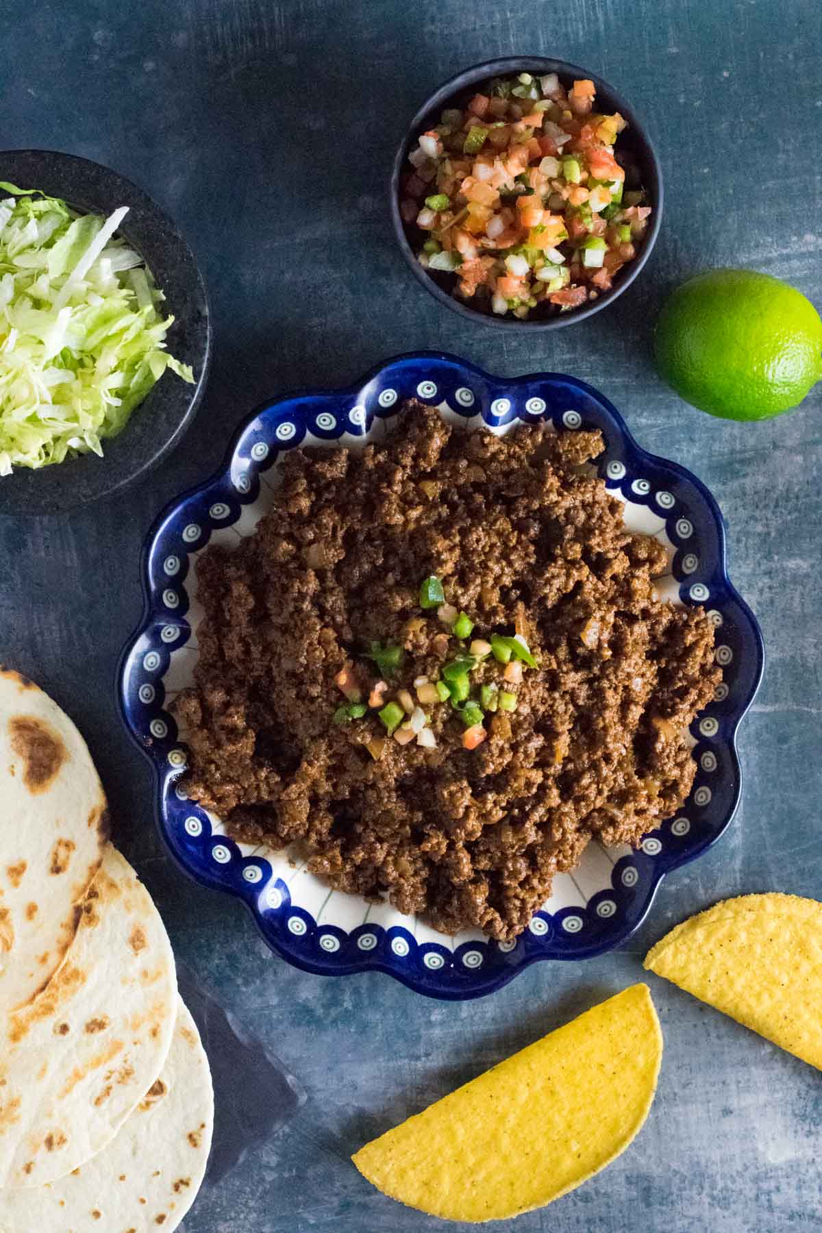 Browned venison and taco ingredients.