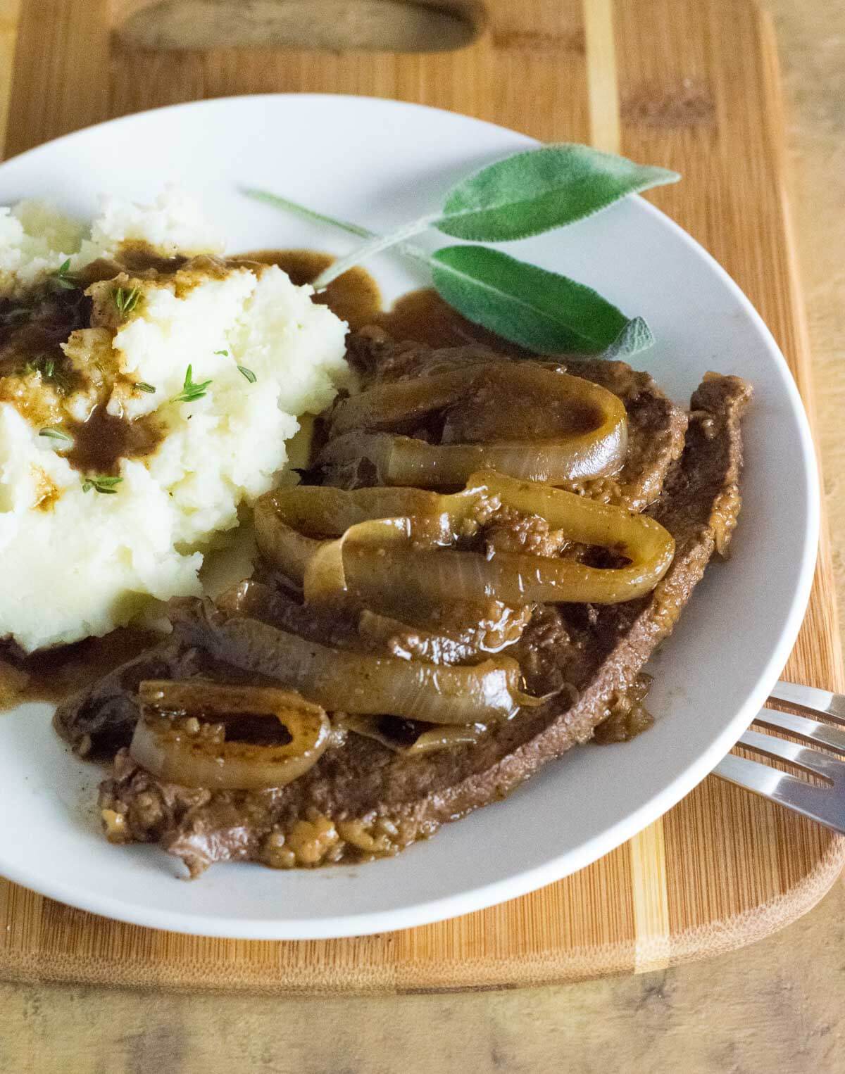 Serving old fashioned liver and onions with gravy and mashed potatoes.