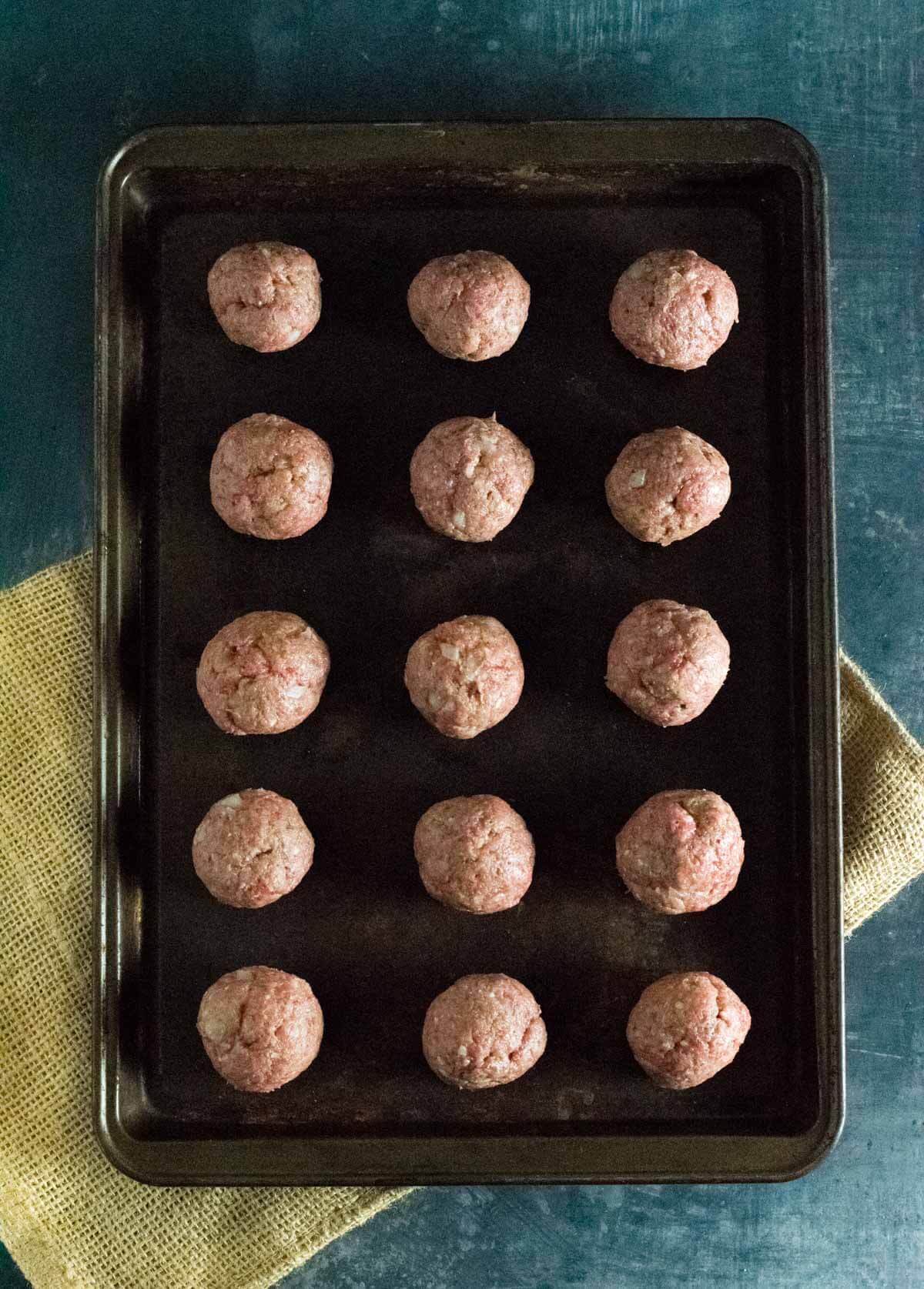 Forming raw Wagyu ground beef meatballs.