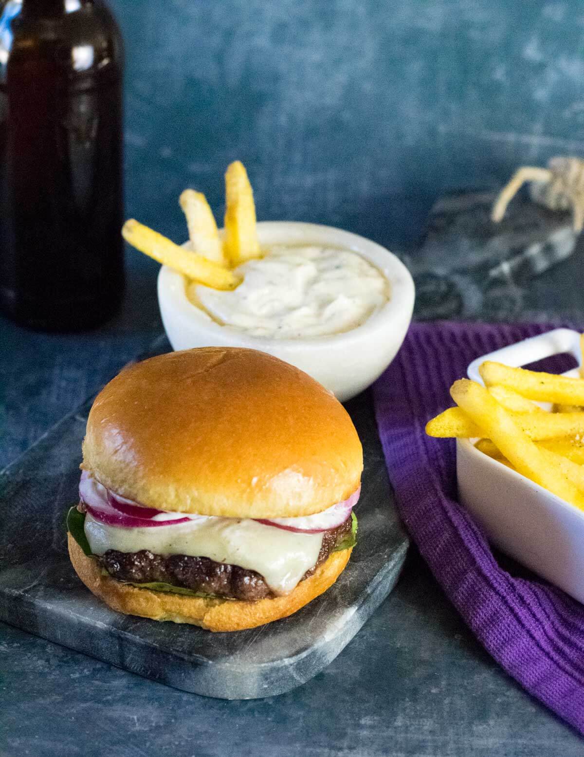 Serving homemade truffle burger with fries.