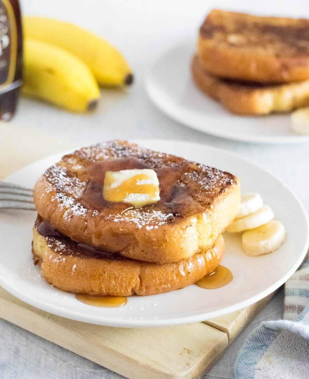 Serving eggless French toast with maple syrup.