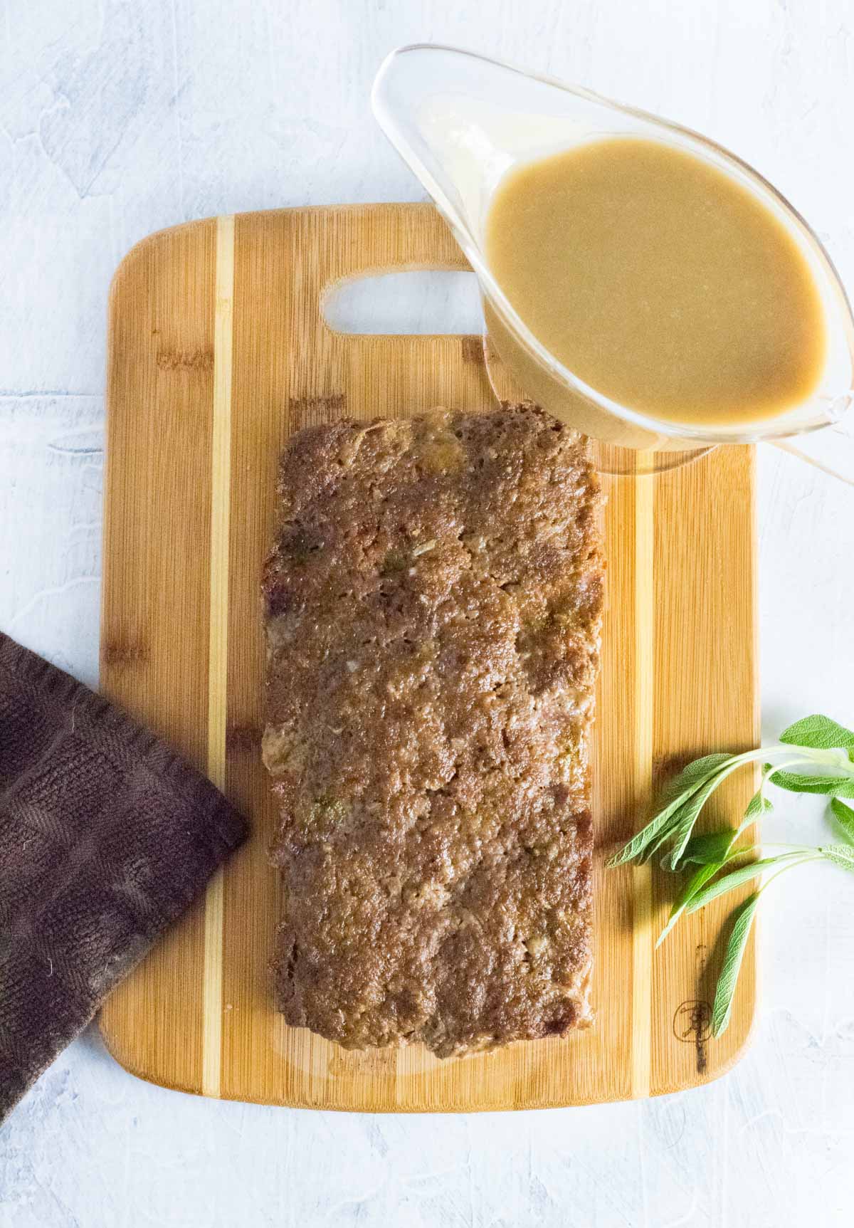 Serving meatloaf with gravy.