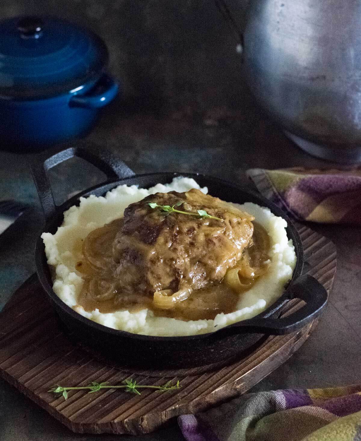 Hamburger steak with onion gravy and mashed potatoes.