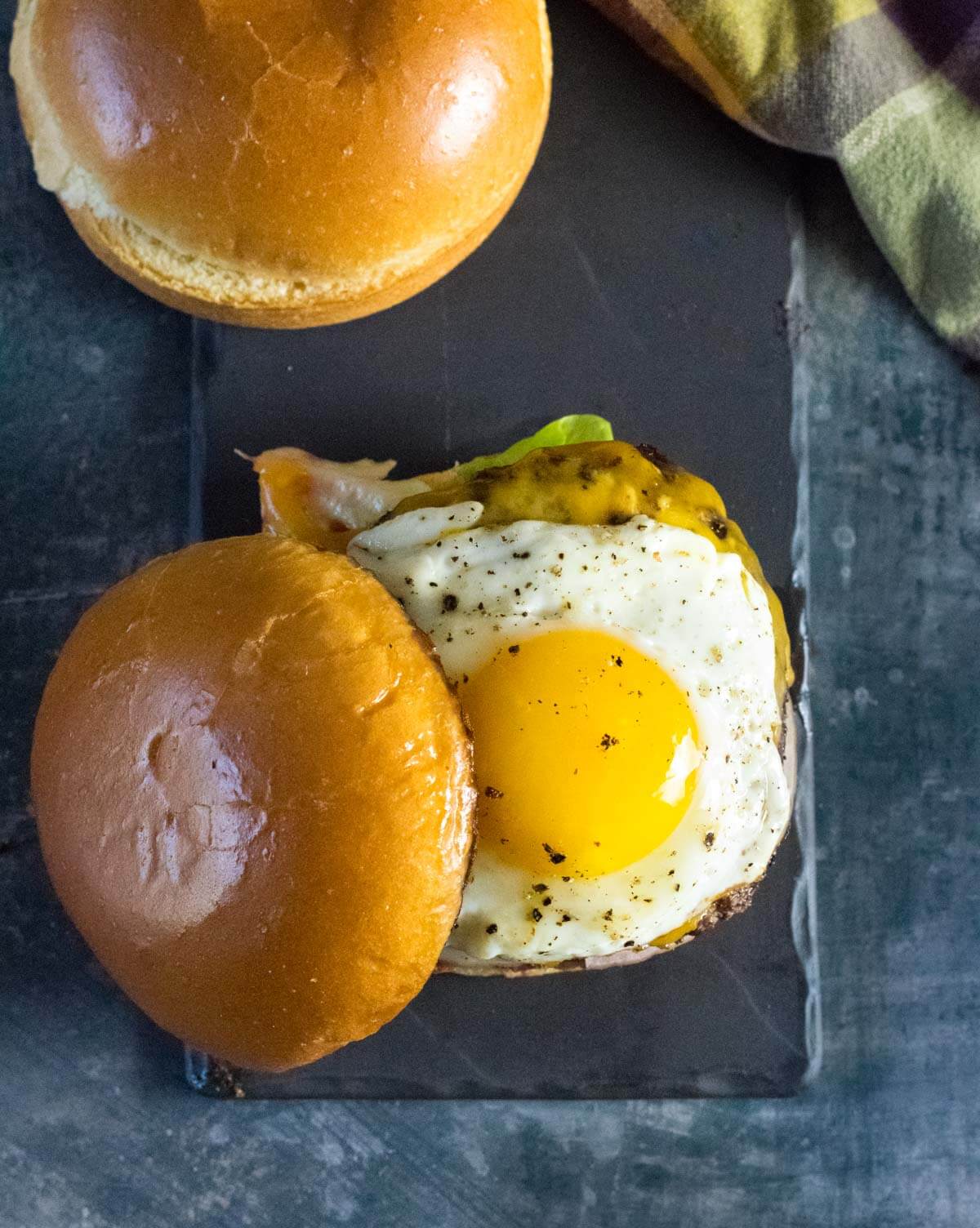 Assembling a fried egg burger.