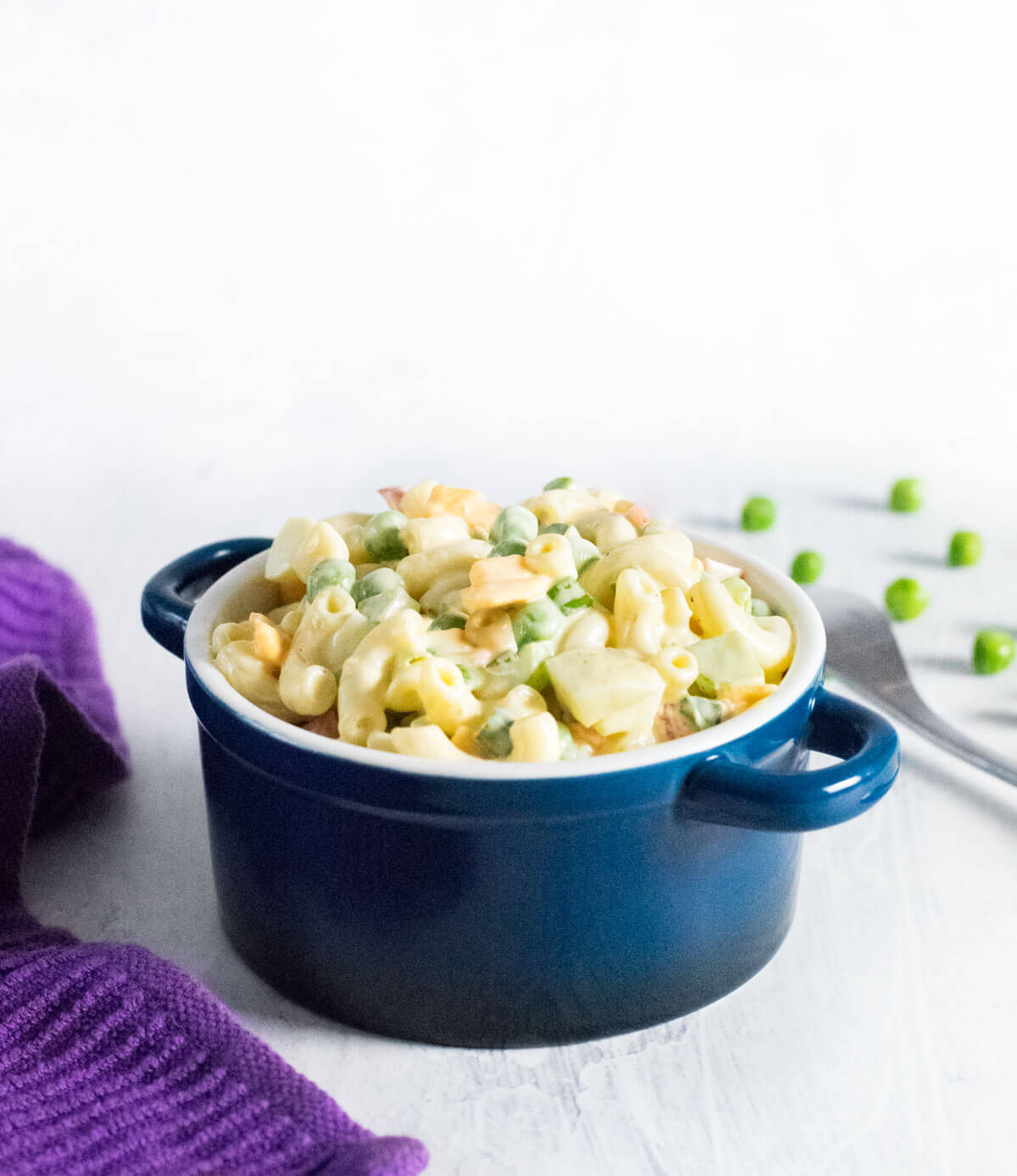 Homemade macaroni salad with peas.