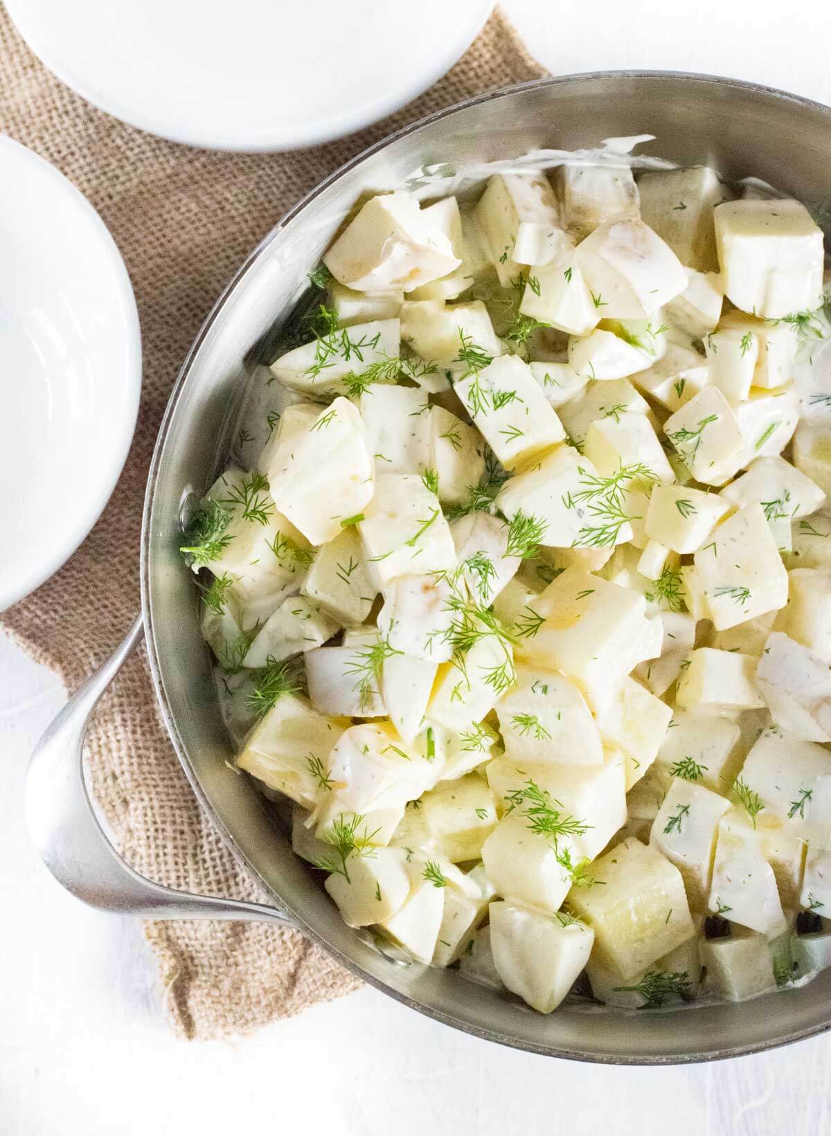 Making potato salad with dill.