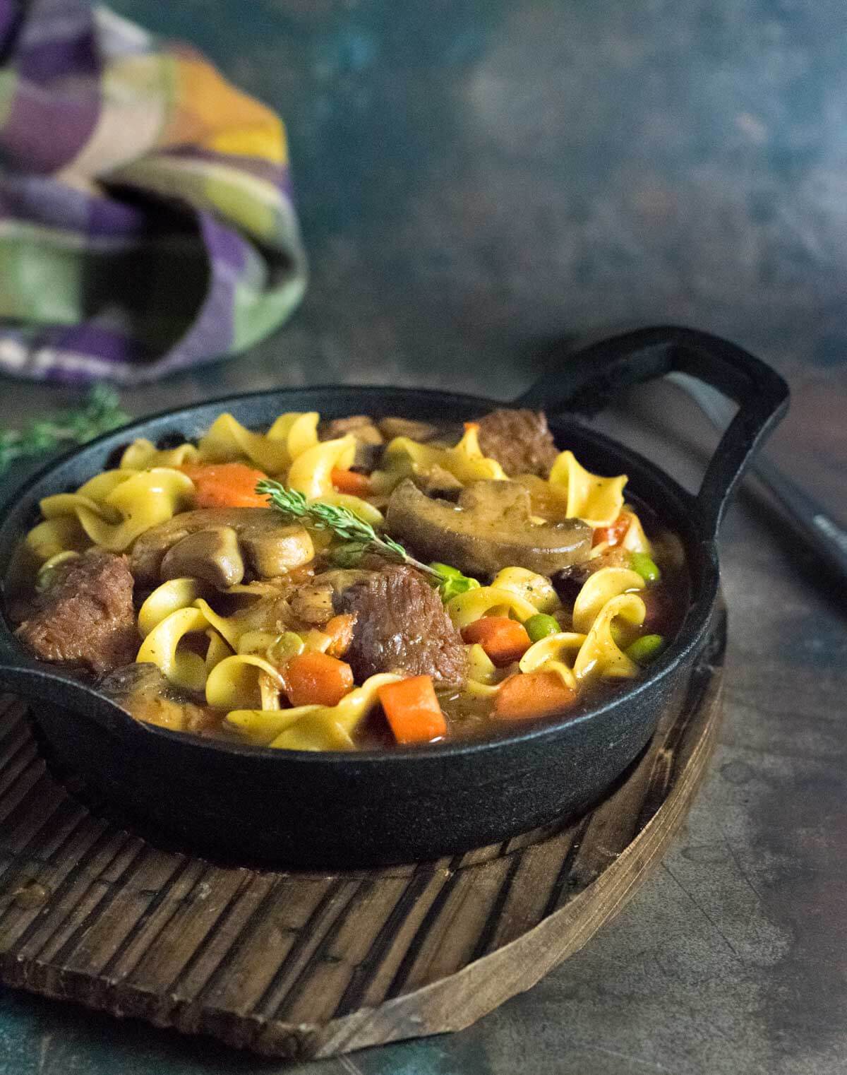 Serving beef noodle stew.