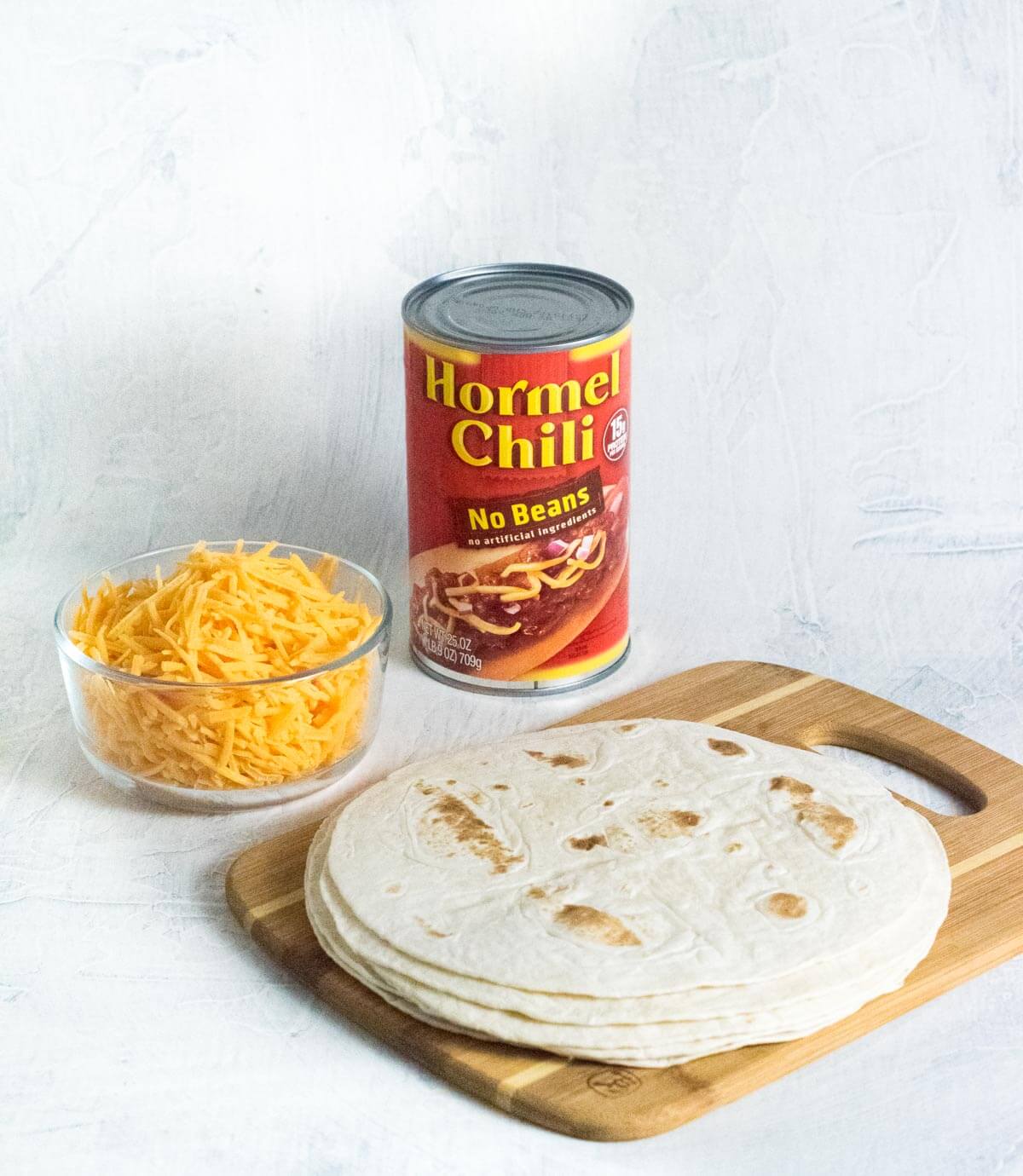 Showing three ingredients for easy chili cheese burritos.