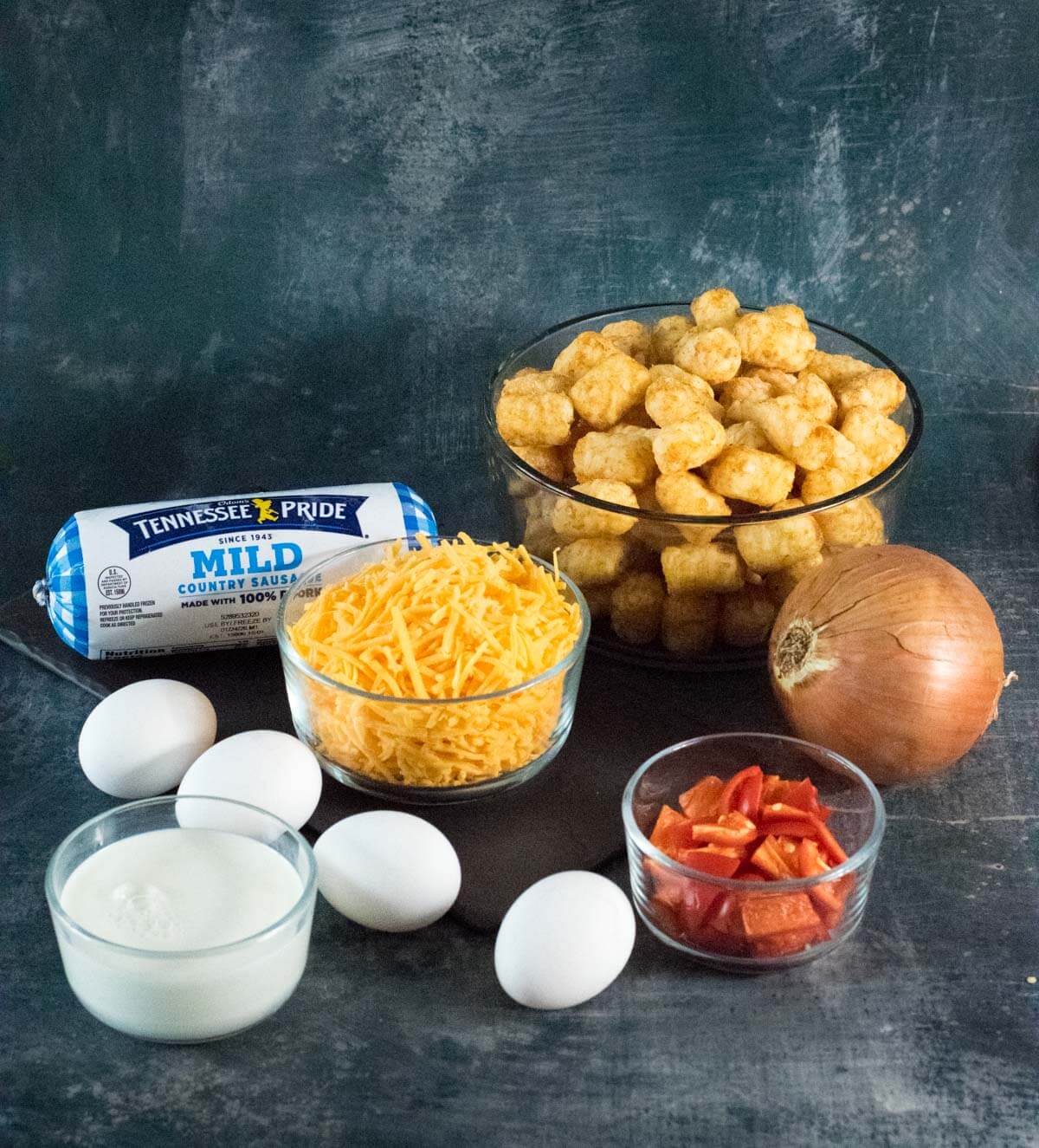 Showing ingredients for tater tot casserole with breakfast sausage.