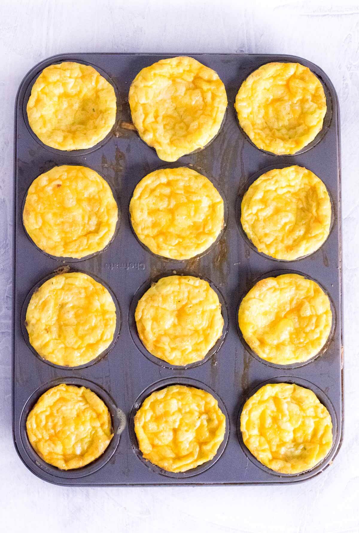 Baking cheesy bacon egg cups.