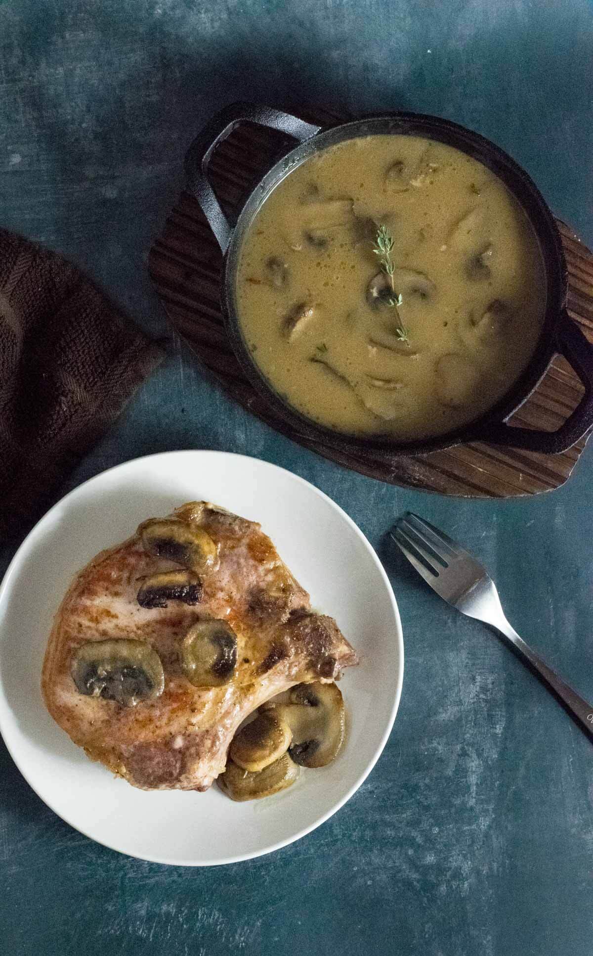 Serving baked pork chops with gravy.